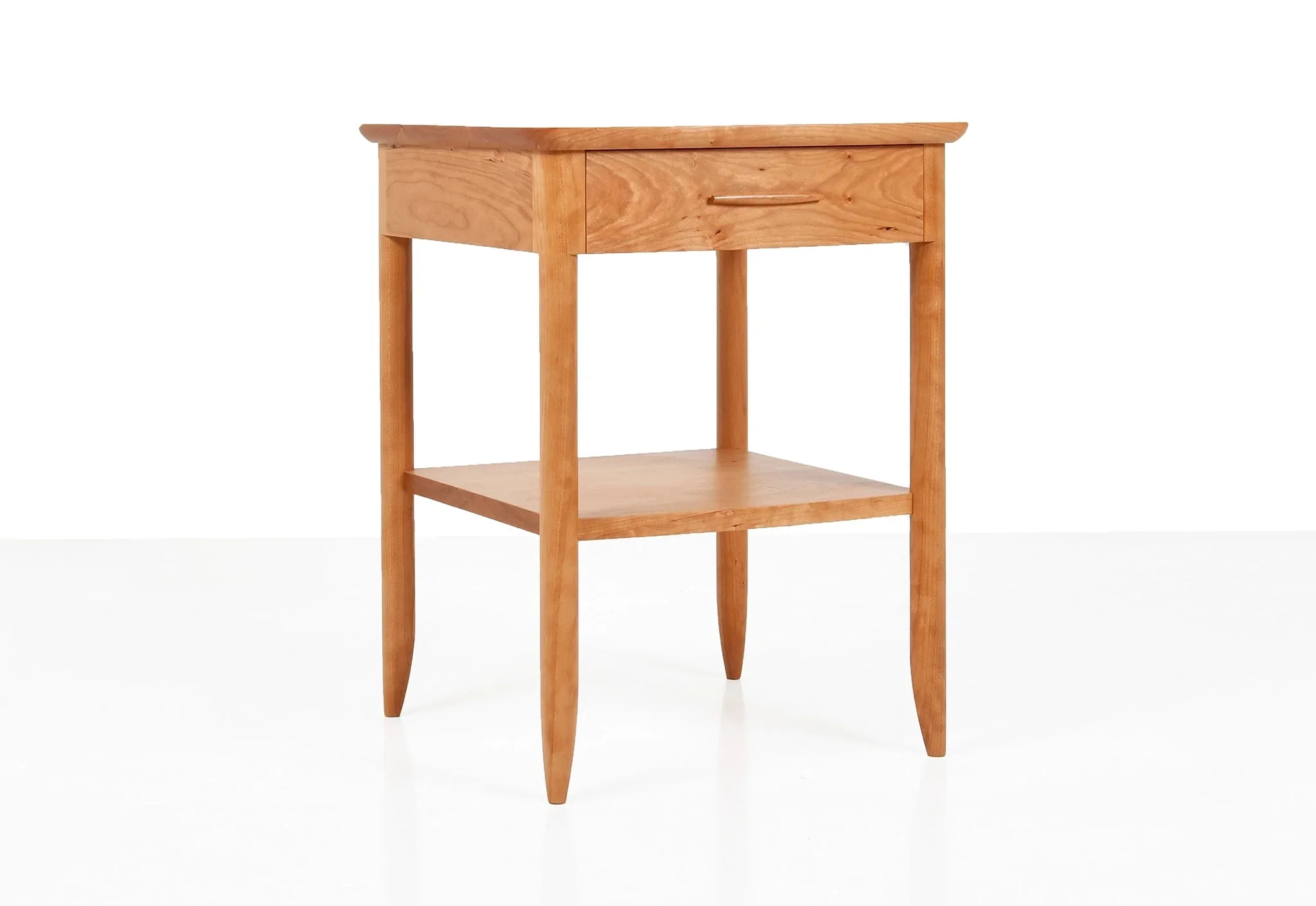 Side Table - The collection is united through the tapering of the legs and the gently curved details
